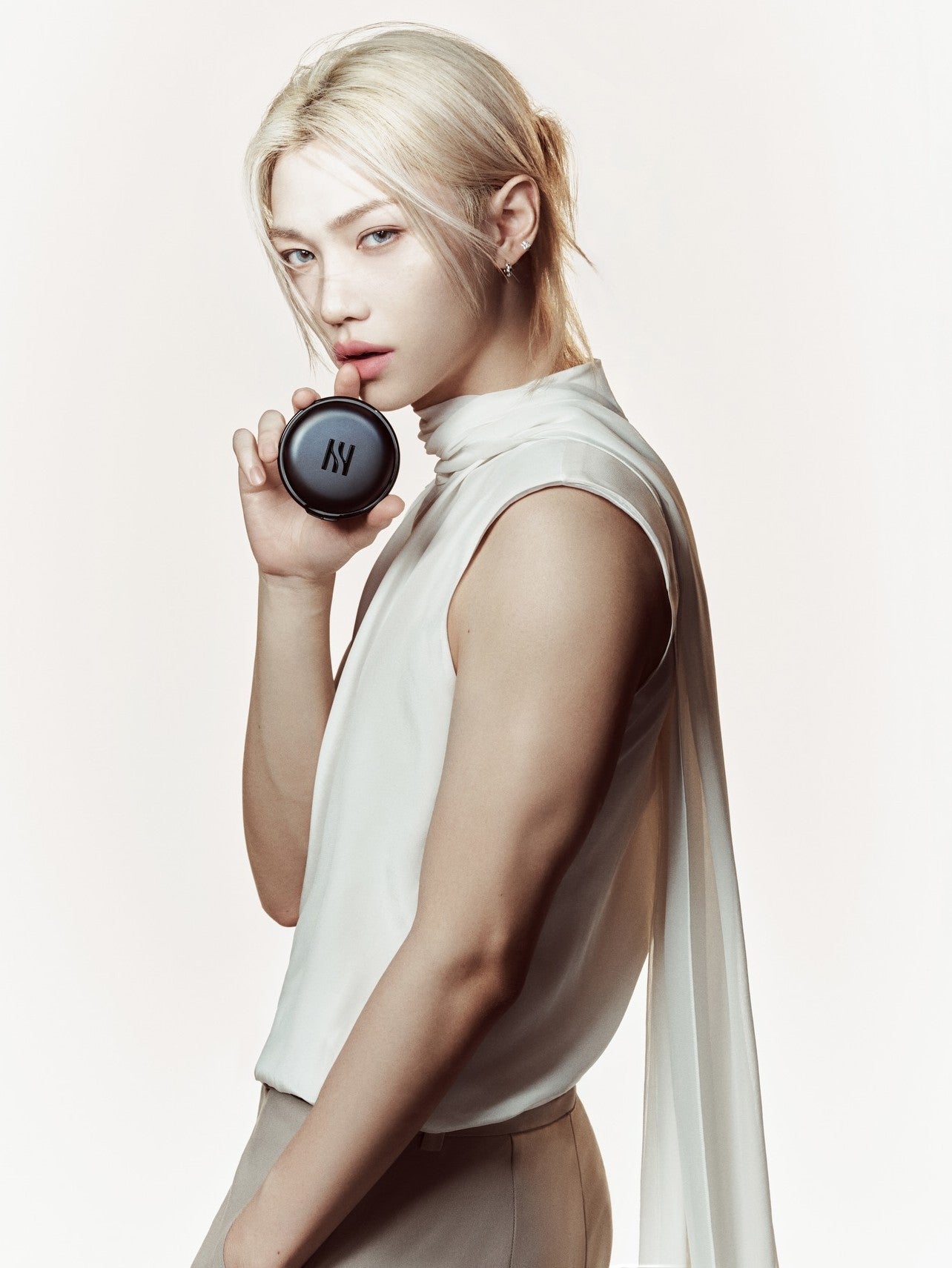 Woman holding a black object against a light background