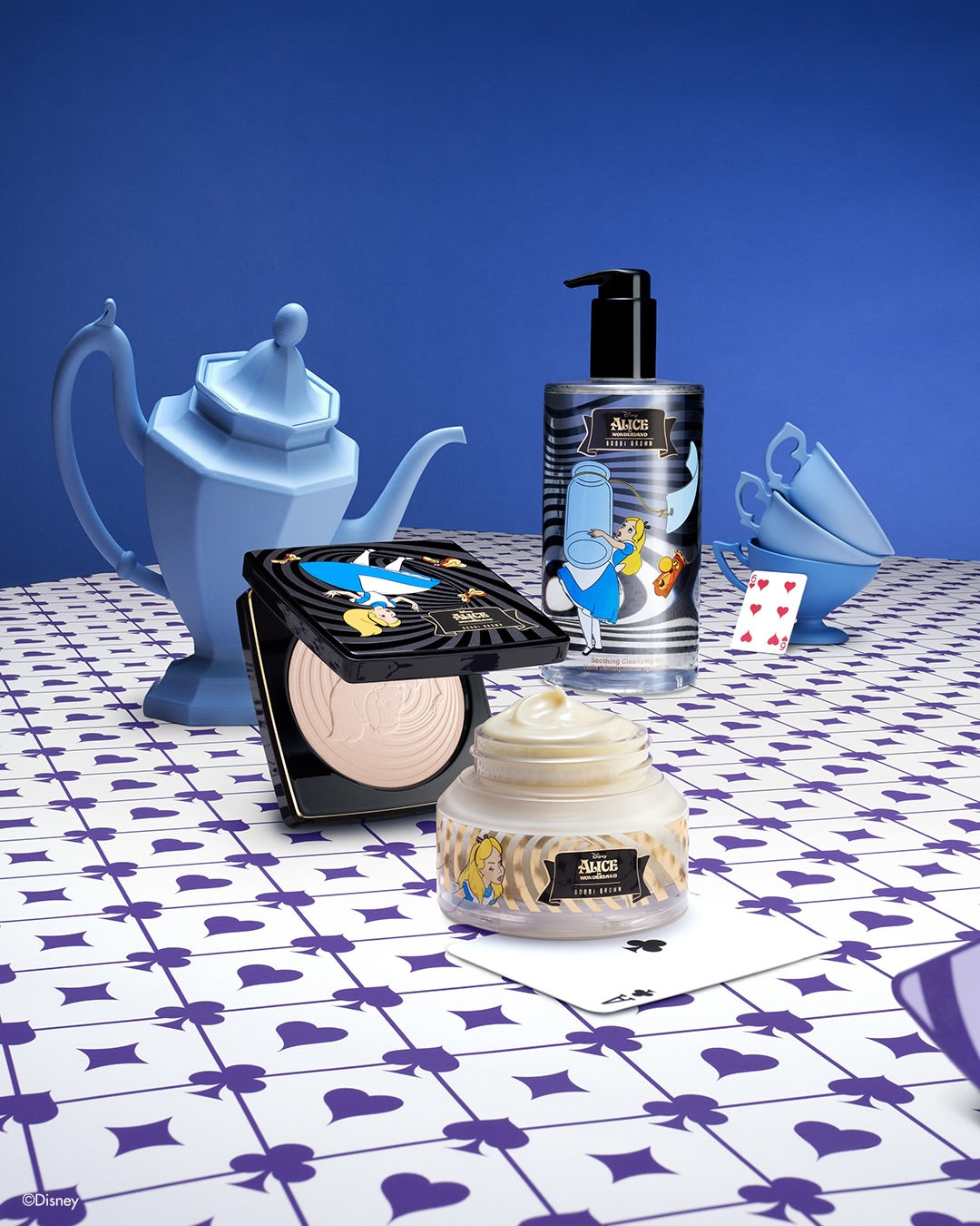 Cosmetic products with Alice in Wonderland design on a patterned tablecloth