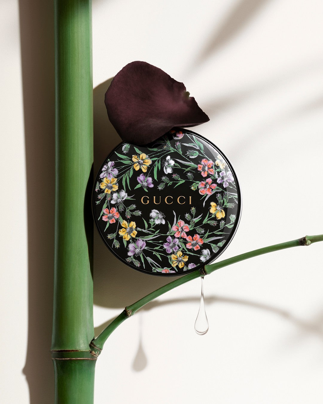 Gucci compact mirror with floral design on a bamboo branch