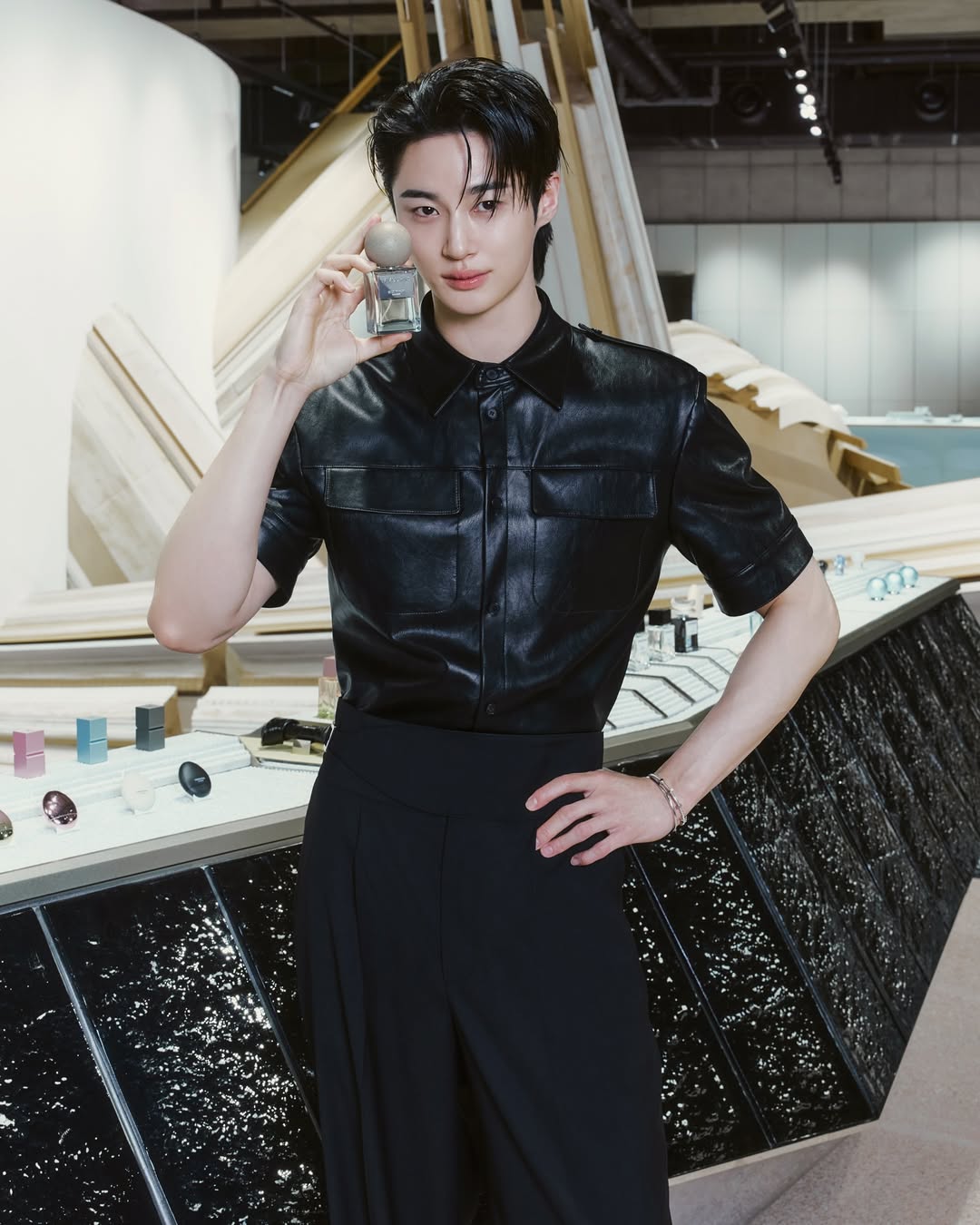 Person wearing a black leather outfit in an indoor setting