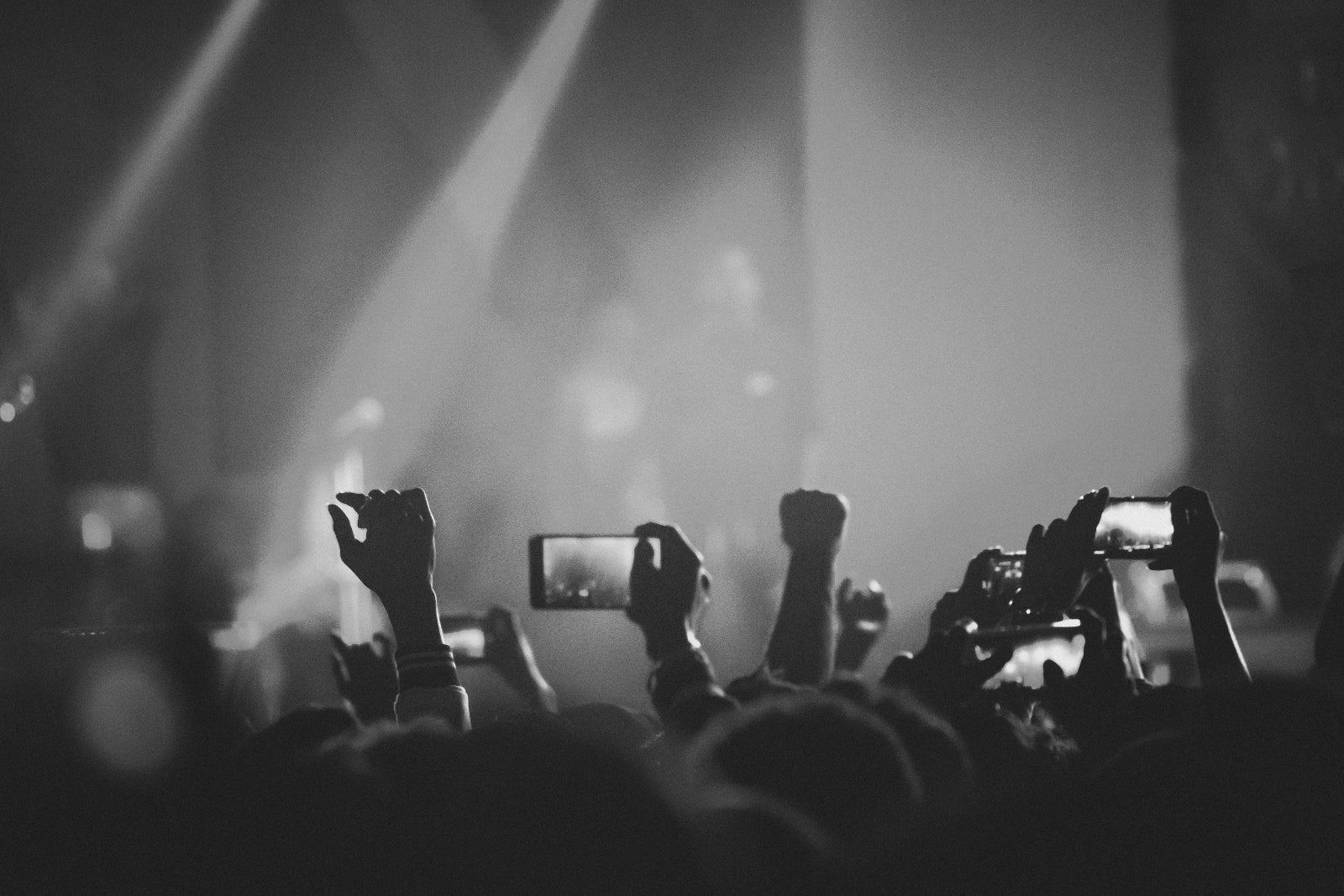 audience-members-hold-up-mobile-phones-filming-a-concert