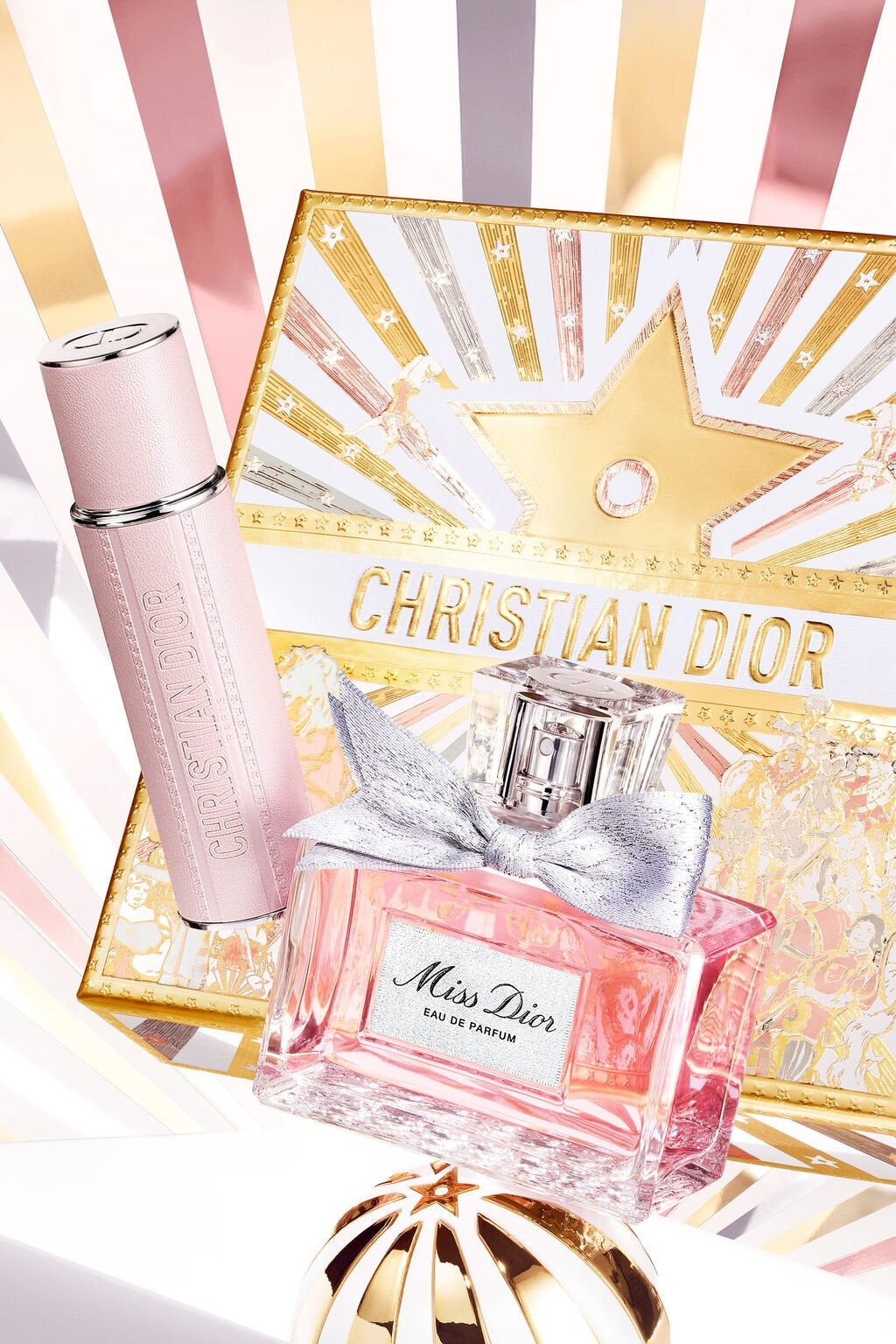 Christian Dior Miss Dior perfume bottle and packaging on a decorative background